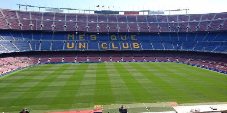 Panoramic view of Camp Nou stadium in Barcelona, home of FC Barcelona football team, with 'Mes Que Un Club' slogan.