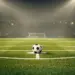 Empty floodlit football pitch with ball on centre spot before match, dramatic shadows and stadium lights.
