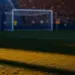 Empty floodlit football stadium at golden-hour with packed stands, dramatic shadows, and cinematic lighting.