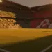 Floodlit World Cup stadium at golden-hour with South African green-gold and Canadian red-white stands, dramatic shadows across empty pitch.