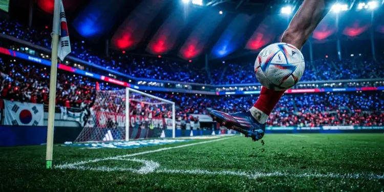Floodlit football pitch with boot and ball in motion, blue and red colour palette, dramatic stadium lighting.