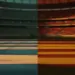 Empty floodlit stadium at dusk showing Uruguay and Spain national colours reflected on pitch