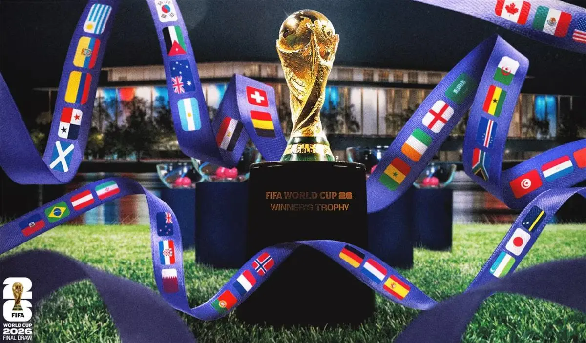 FIFA World Cup 2026 trophy with flags of participating countries on ribbons.