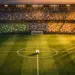 Aerial view of floodlit stadium pitch with centre ball, Group J flag-colour stand sections, pre-match atmosphere.