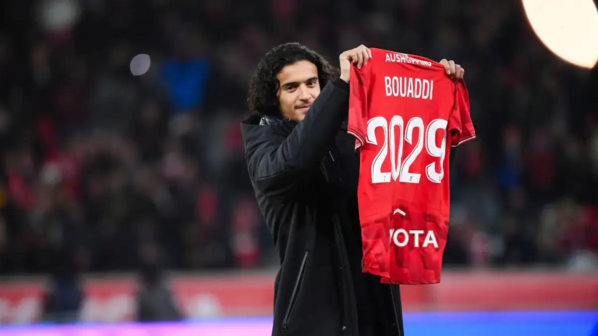 Ayyoub Bouaddi holds up a Lille OSC jersey for 2029 during a stadium event.