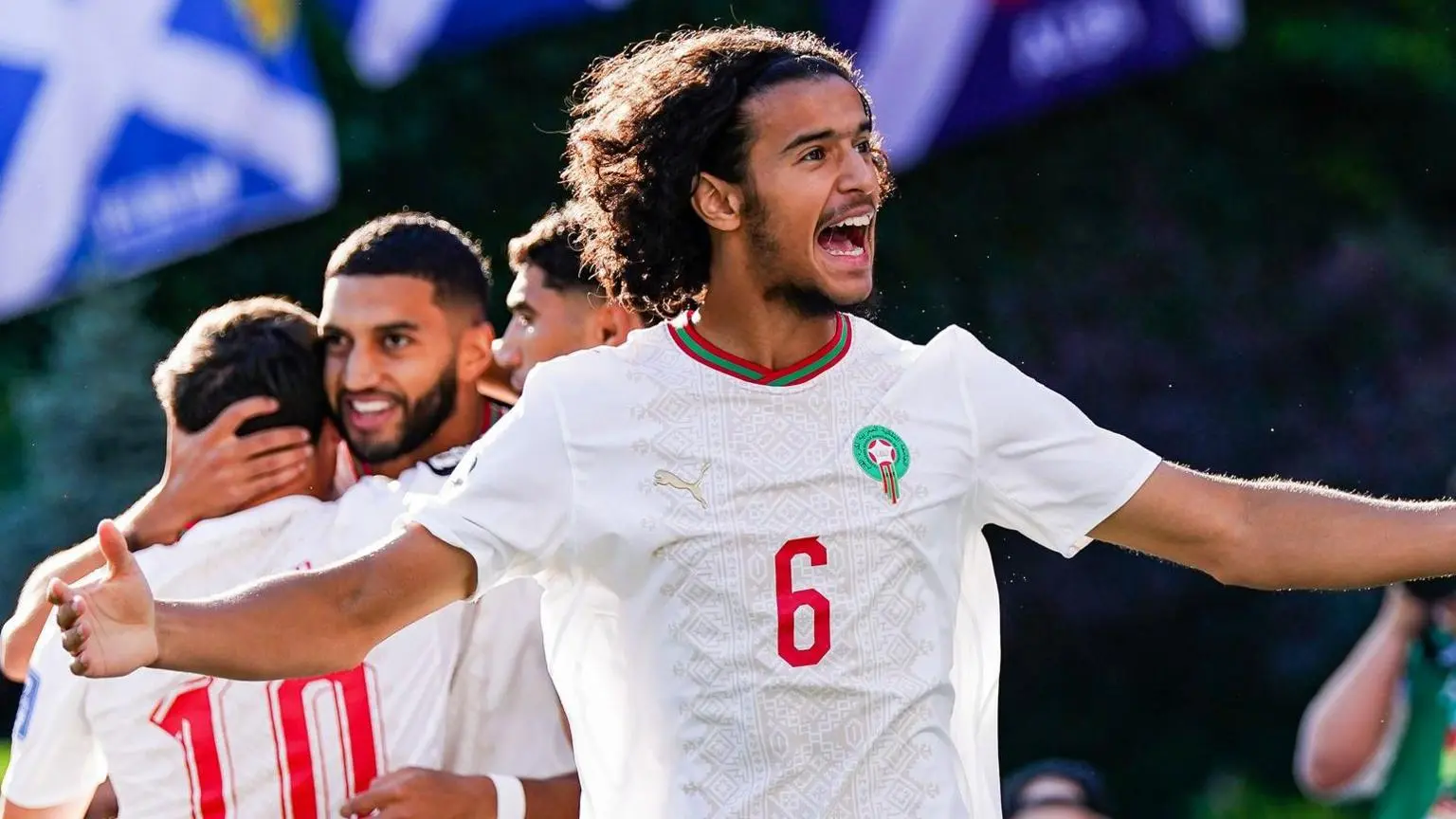 Ayyoub Bouaddi celebrating with Moroccan teammates in a soccer match.