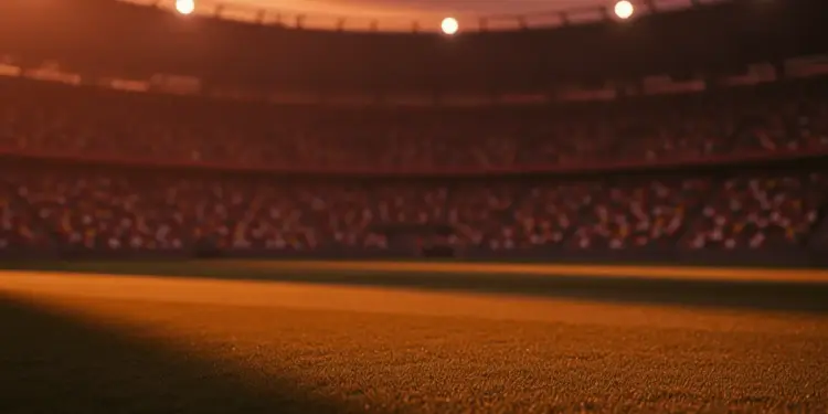 Floodlit stadium pitch at dusk with national colour stands, low-angle view, shadow patterns, no players.