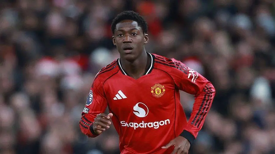 Kobbie Mainoo in a red Manchester United home kit during a match