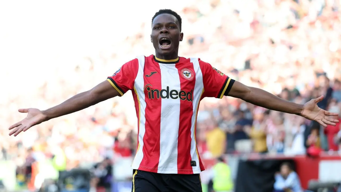 Mamadou Sangaré celebrating with arms outstretched in a red and white striped Southampton FC kit