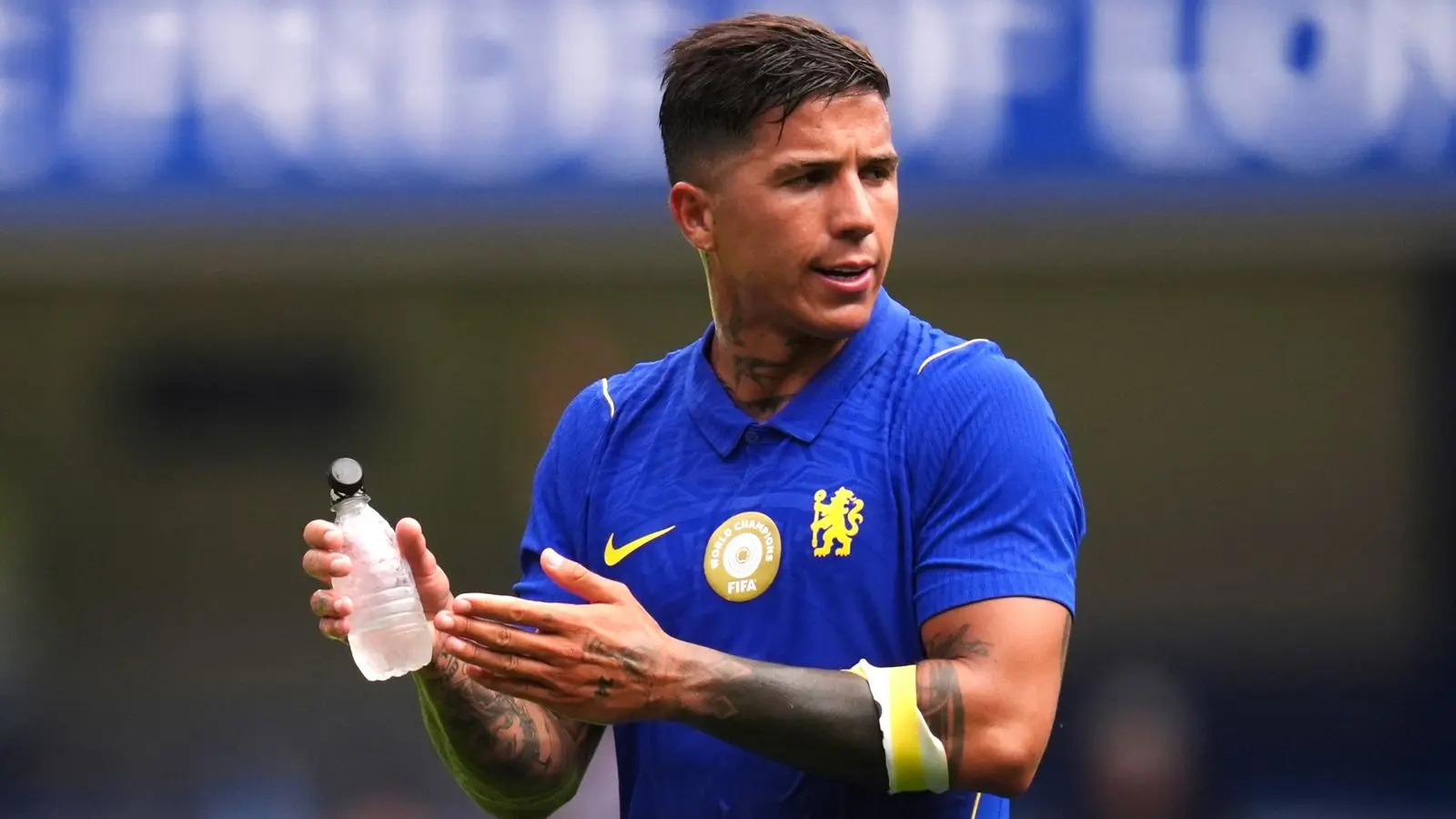 Enzo Fernandez in a blue Chelsea FC kit holding a water bottle