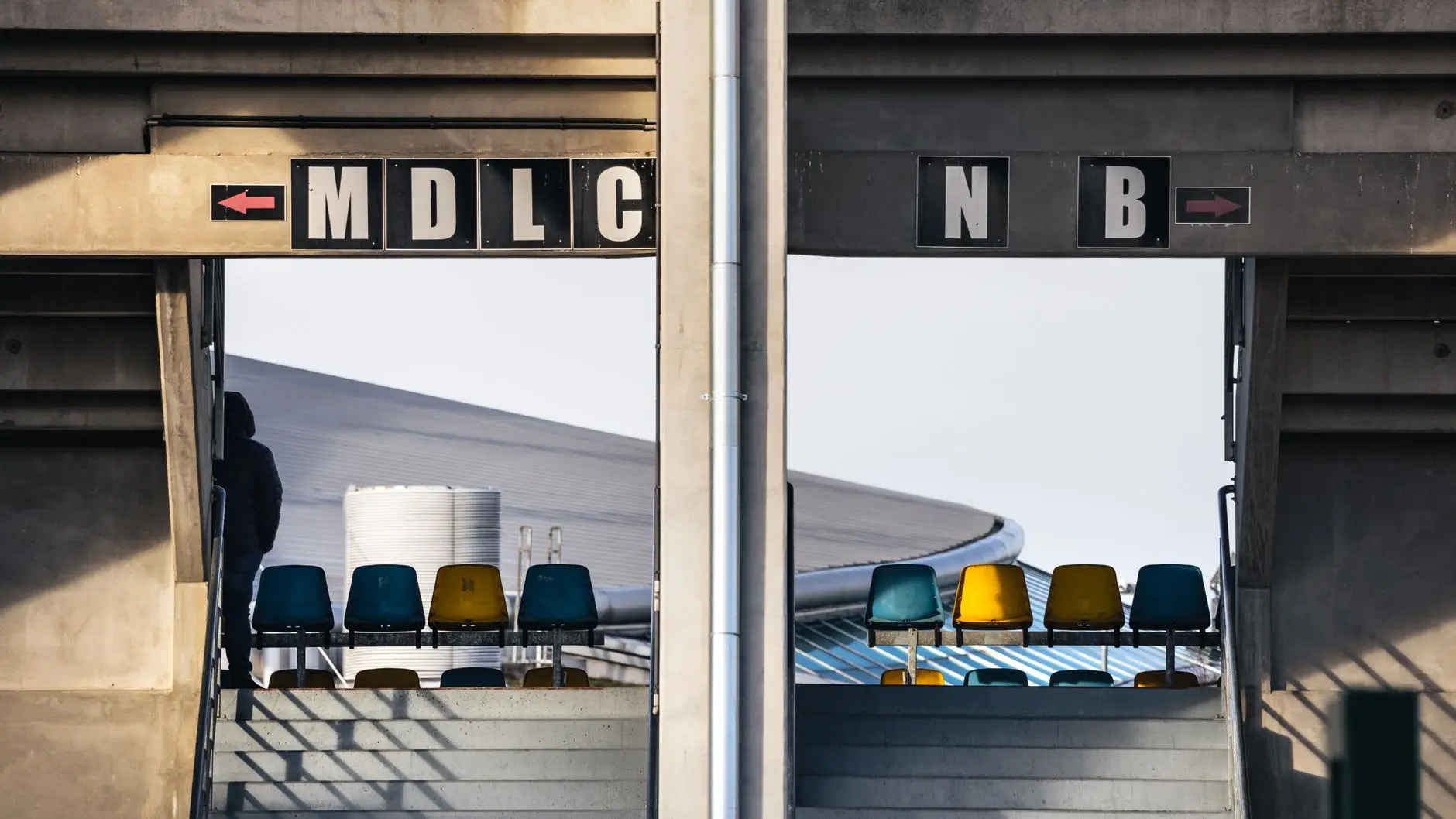 Detail of seating and signage at the MKM Stadium, showing 'MDLC' and 'NB' block indicators.